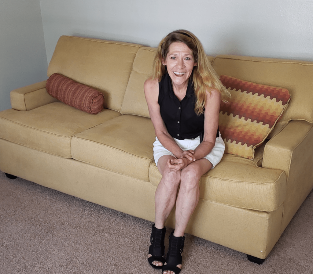 Tammy sitting on couch, smiling